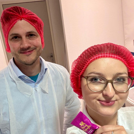 Monty team members in red hair nets at the factory